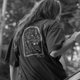 Beach Wavey hair model wearing Goofy Apparel Dark Brown T with back graphic