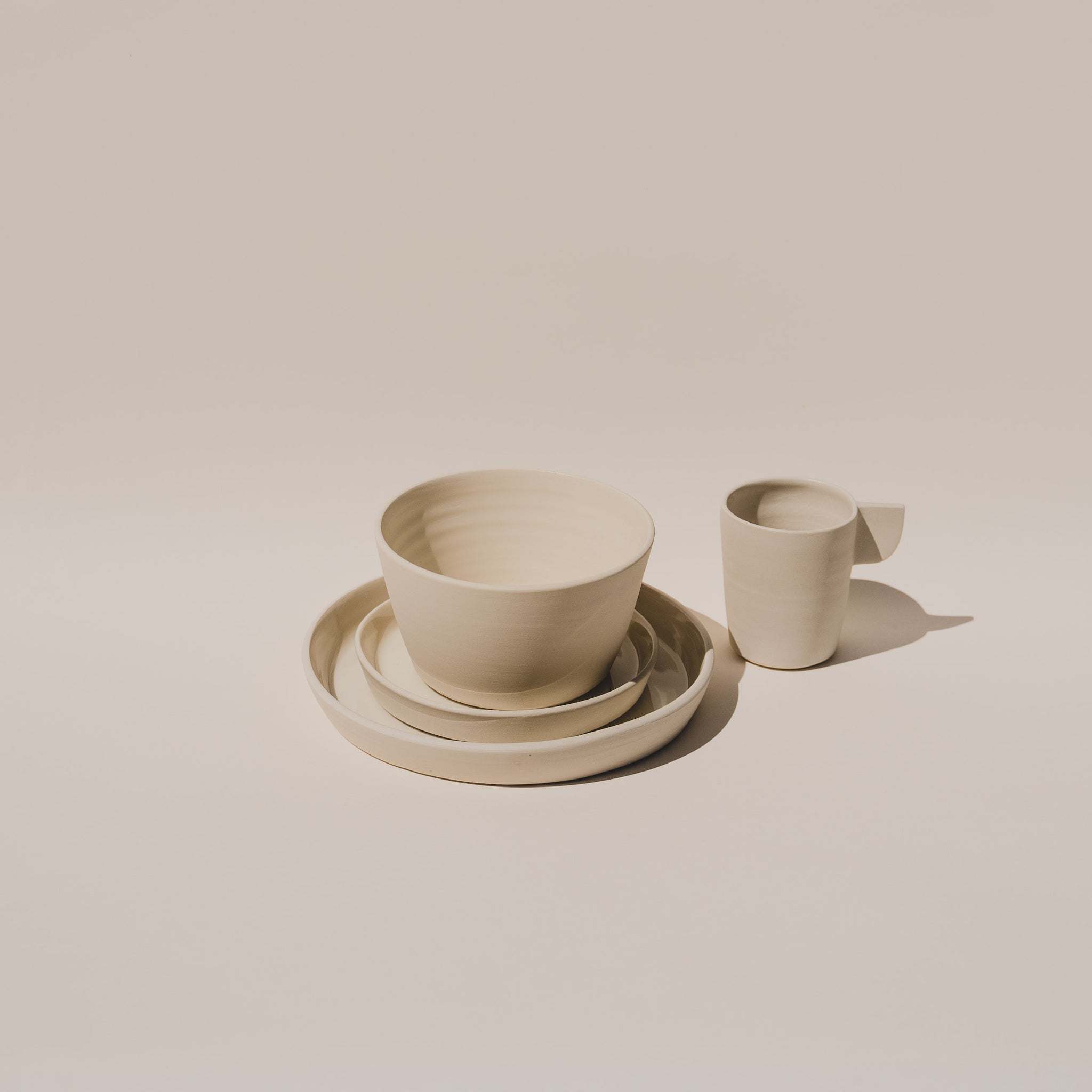 Ceramic plate set with ceramic bowl and ceramic mug in white
