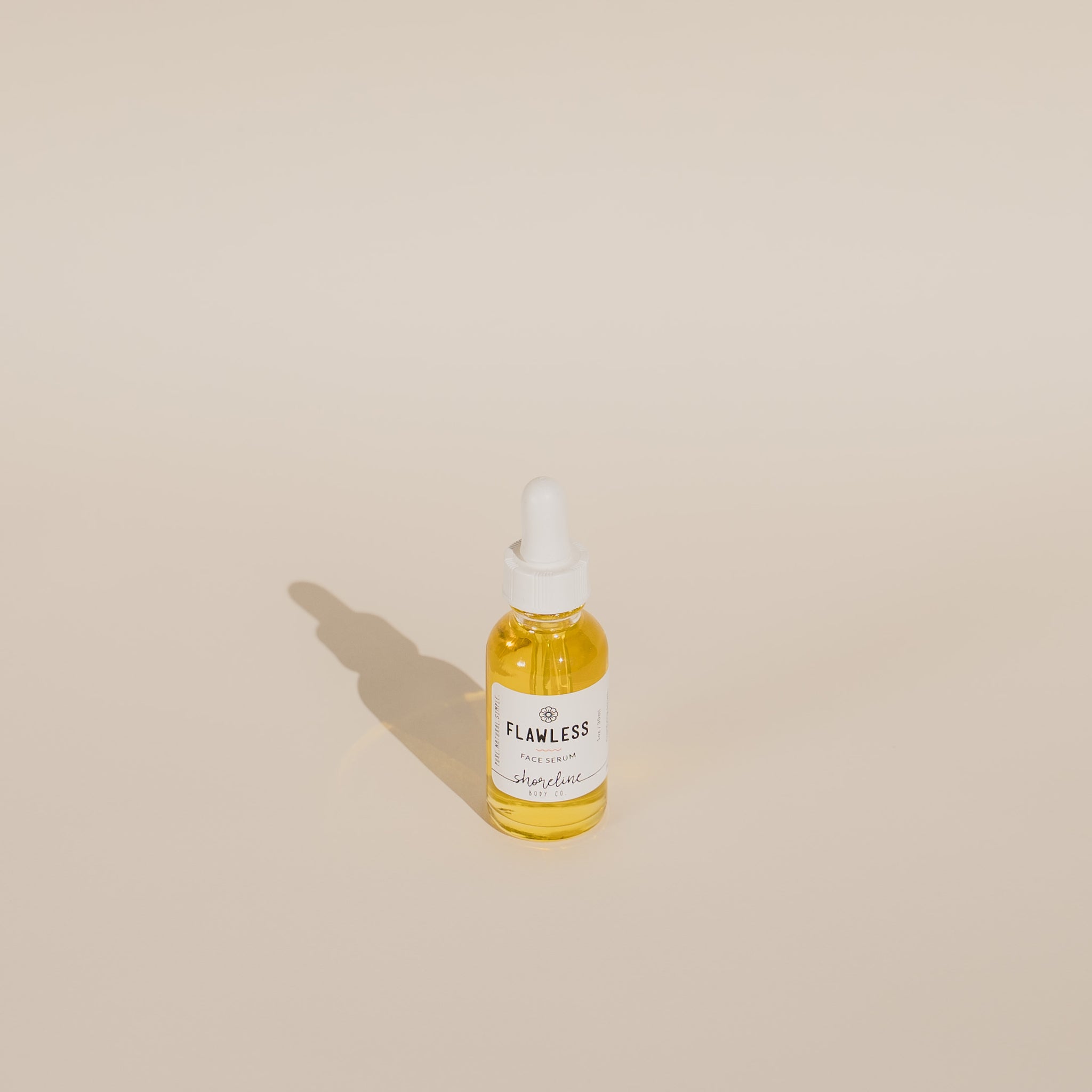 The Flawless Face Serum is pictured against a white background. 