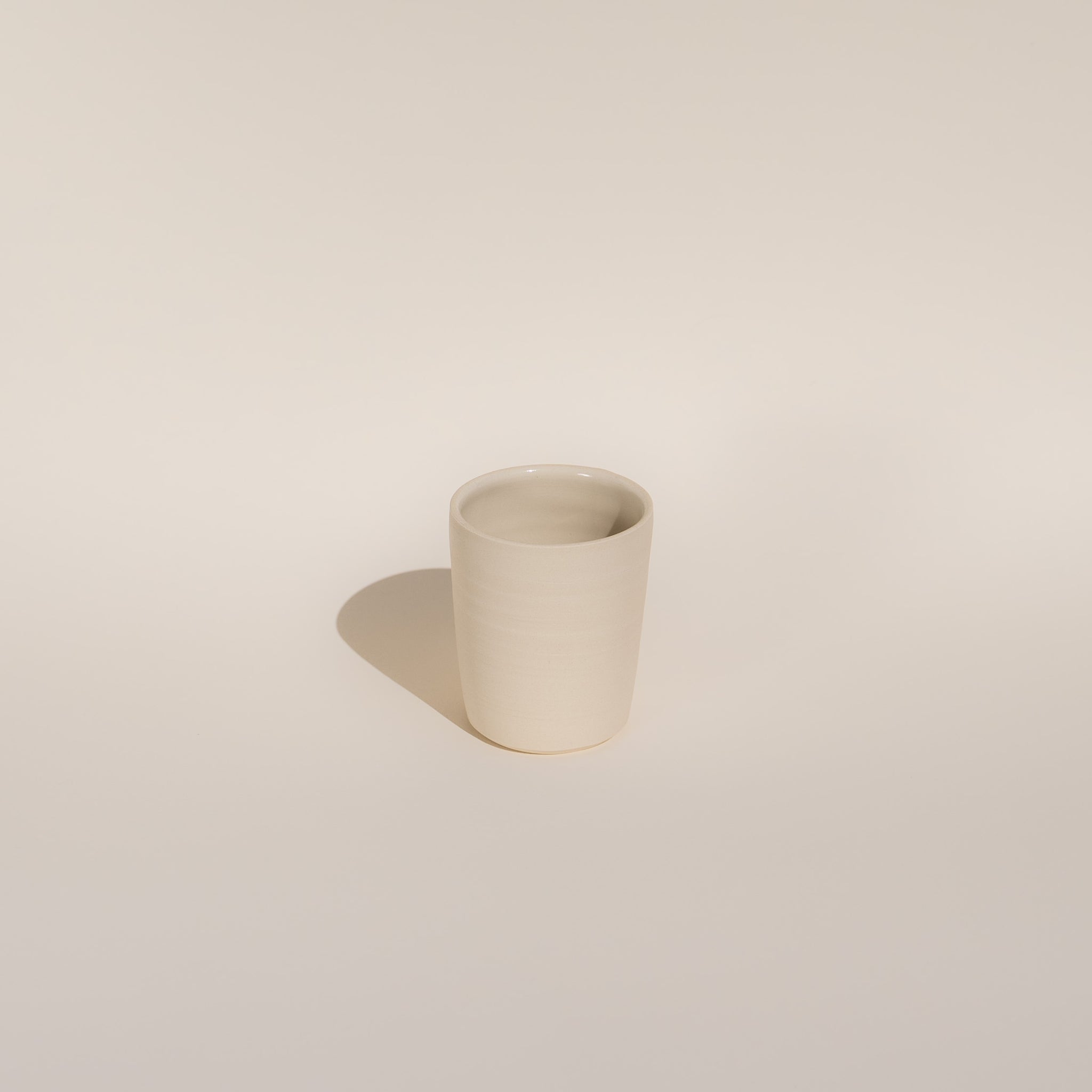 white ceramic tumbler